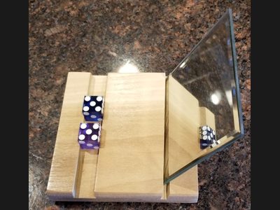 The Golden Touch Gripper dice grip training aid with mirror and stand - perfect finger placement for dice control